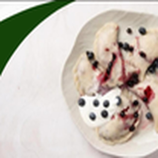 Blueberry pierogi with cream and berries